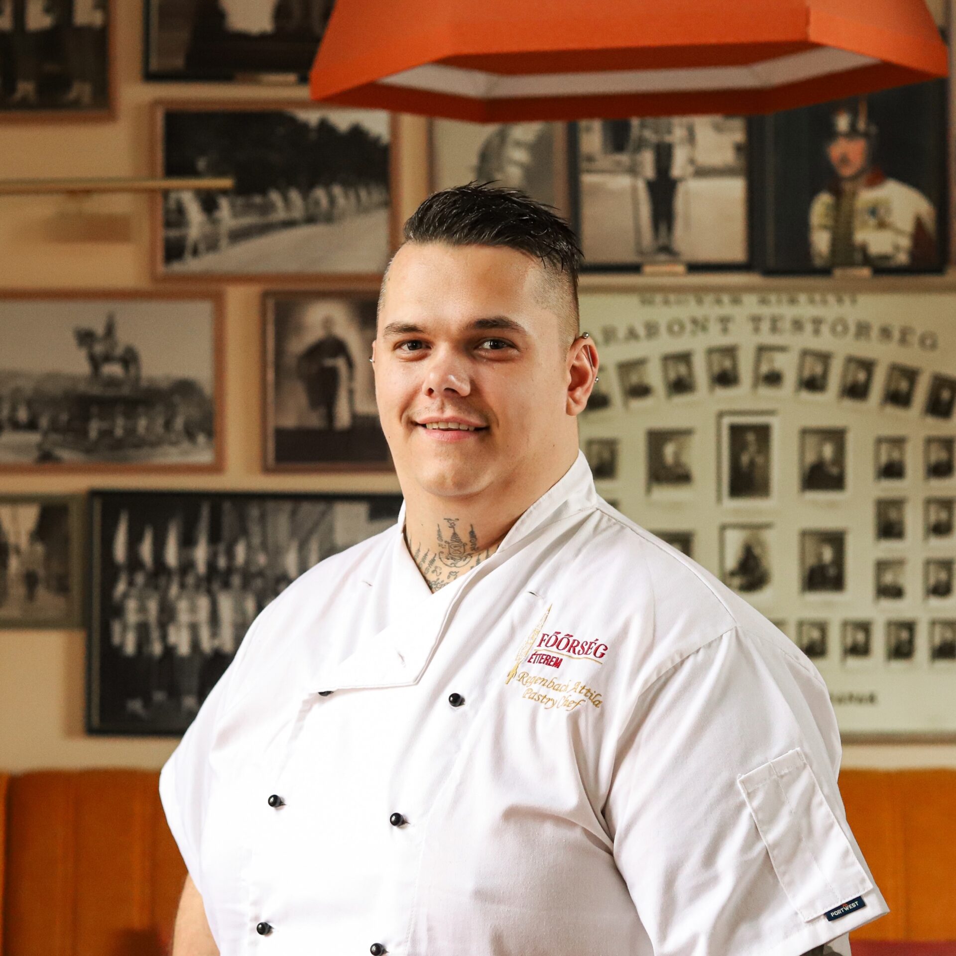 Főőrség Rendezvénytere terített asztalokkal, gyertyatartókkal és faliképekkel a háttérben